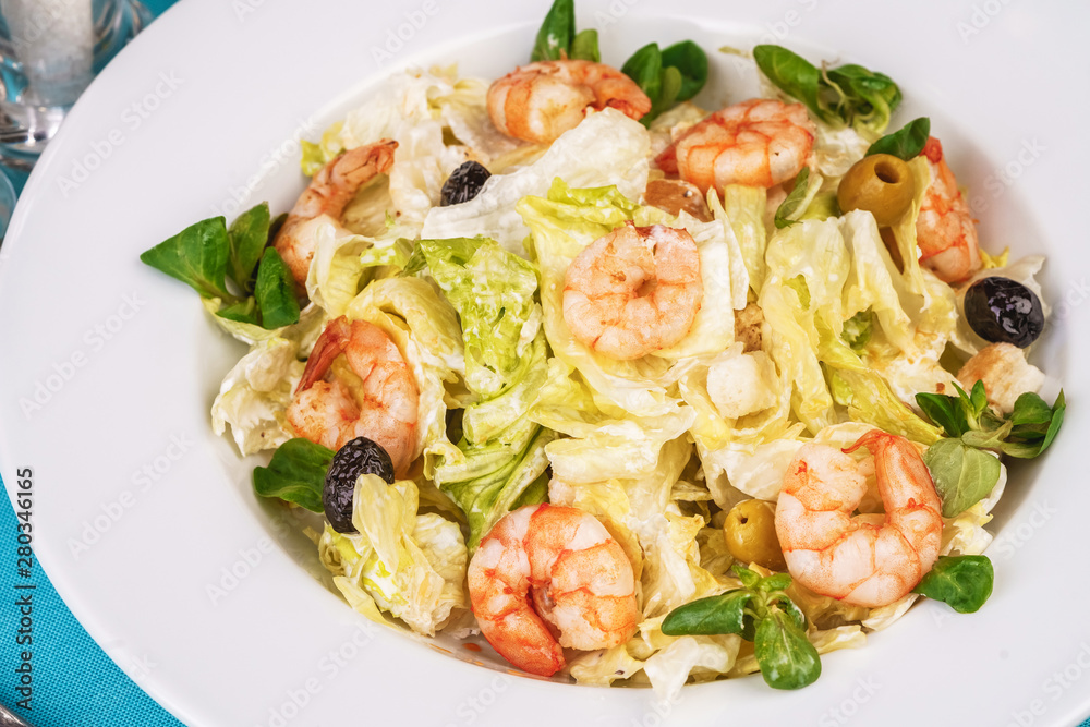 Mediterranean salad. Cabbage, tomatoes, shrimps, olives, olives, basil and rosemary, seasoned with olive oil Mediterranean salad. Cabbage, tomatoes, shrimps, olives, olives, basil and rosemary, seasoned with olive oil
