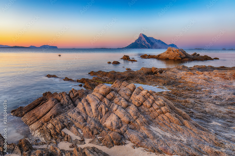 Fantastic azure water with rocks near beach Porto Taverna at sunset - obrazy, fototapety, plakaty 