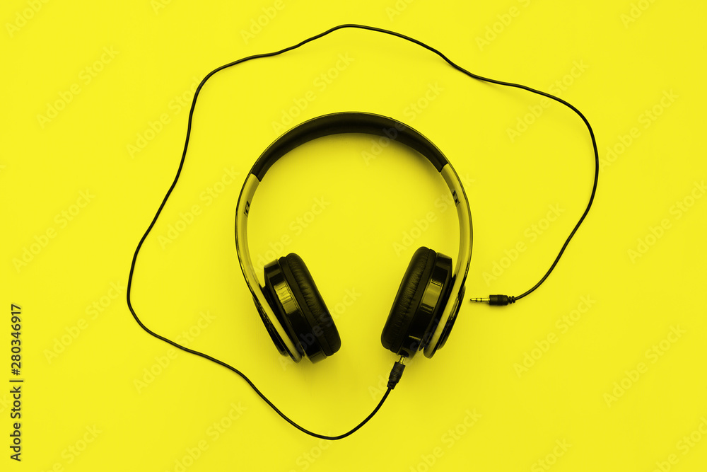 Headphones on yellow background with free text space. Music concept. Headphones on yellow background with free text space. Music concept.