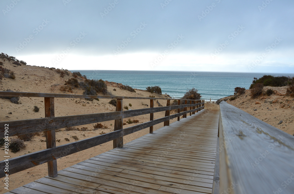 Wooden Foothpath to an Empty Beach in Costa Calma, Fuerteventura Wooden Foothpath to an Empty Beach in Costa Calma, Fuerteventura