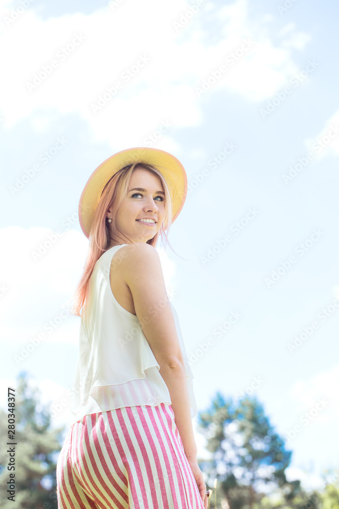 girl in a hat in the sun
