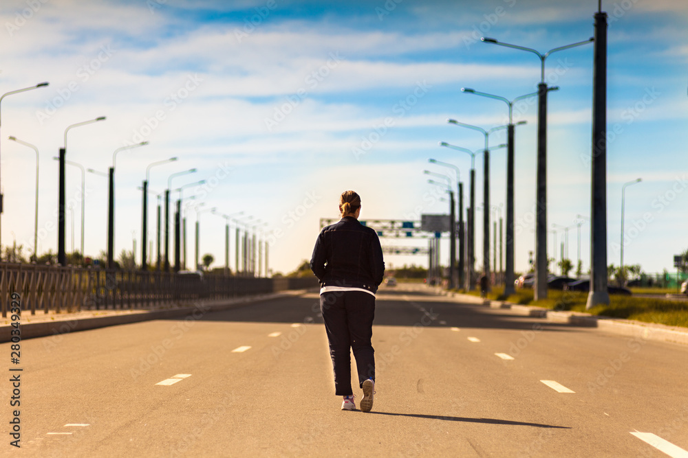 fat young woman walking on the road in hot sunny day fat young woman walking on the road in hot sunny day