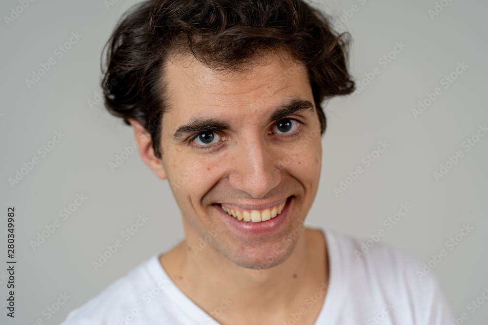 Fototapeta premium Portrait of young attractive cheerful man with smiling happy face. Human expressions and emotions