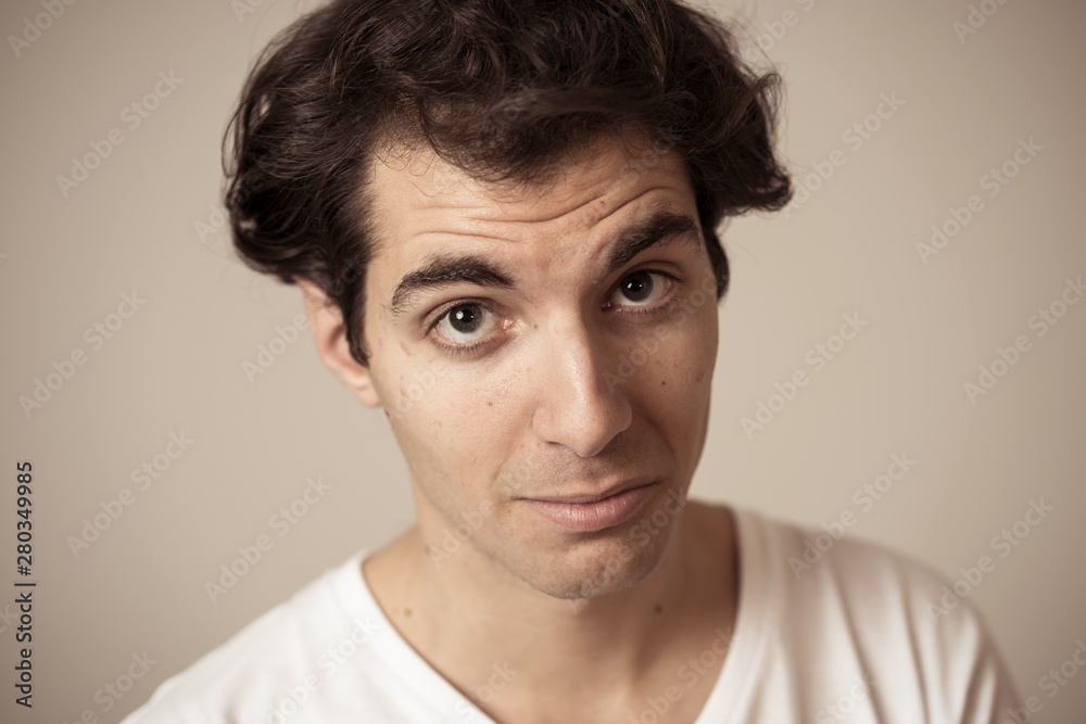 Funny face. Portrait of young man making amusing gestures Funny face. Portrait of young man making amusing gestures