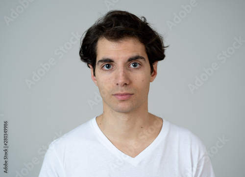 Natural portrait of young attractive man in his 20s looking and posing with neutral face expression © SB Arts Media