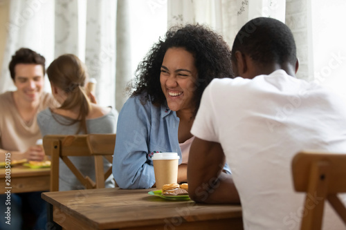 Happy young mixed race girl attending speed dating.