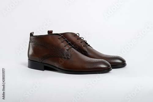 Classic men's shoes on a white isolated background. Angle view from the front.