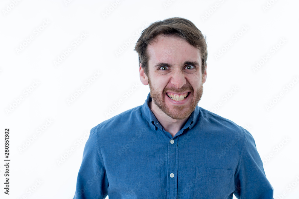 Happy young attractive man having fun making funny faces Happy young attractive man having fun making funny faces