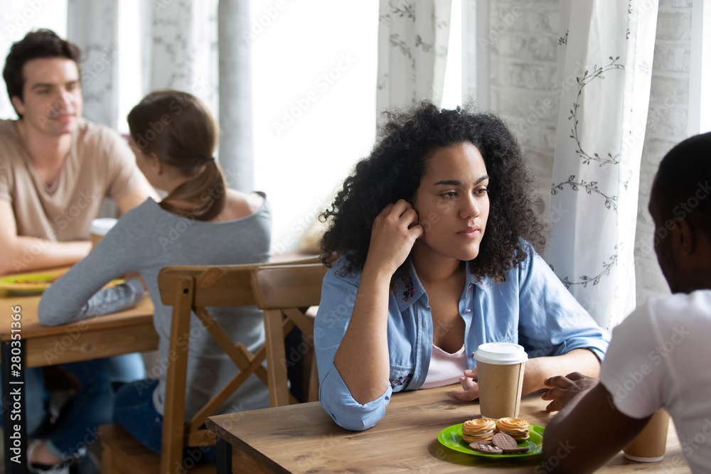 Young biracial woman attending speed dating event. Young biracial woman attending speed dating event.