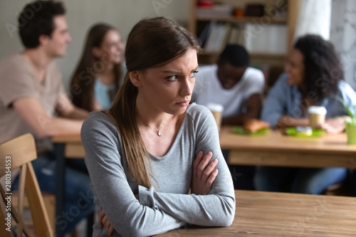 Photos Upset offended by friends young woman sitting alone.