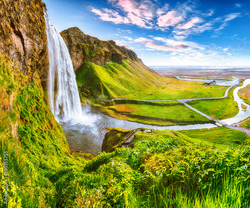 Beautiful scenery of the majestic Skogafoss Waterfall in countryside of Iceland in summer.