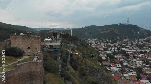 Aerial video of the Old Tbilisi center from above. Drone top view of historical part of city Dzveli Tbilisi. Kura or Mtkvari river below.