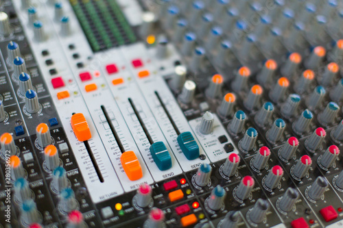 Analog sound mixer with selected focus. Professional audio mixing console radio and television broadcasting. Horizontal shot.