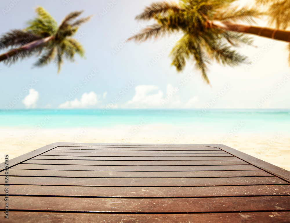 Fototapeta premium Table background with beautiful blue ocean and sandy beach view in distance.