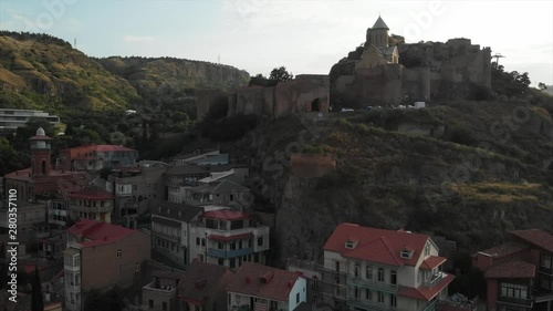 Aerial video of the Old Tbilisi center from above. Drone top view of historical part of city Dzveli Tbilisi. Kura or Mtkvari river below.