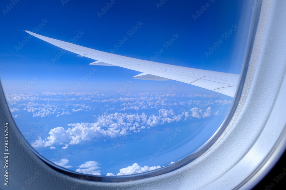 View of the wing of the aircraft and the clouds from the porthole