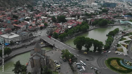 Aerial video of the Old Tbilisi center from above. Drone top view of historical part of city Dzveli Tbilisi. Kura or Mtkvari river below.