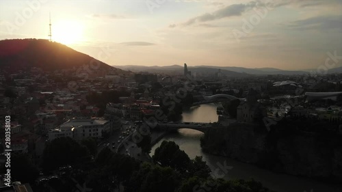 Aerial video of the Old Tbilisi center from above. Drone top view of historical part of city Dzveli Tbilisi. Kura or Mtkvari river below.
