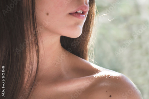 Close-up of a teenage girl's shoulder, neck and chin  photo