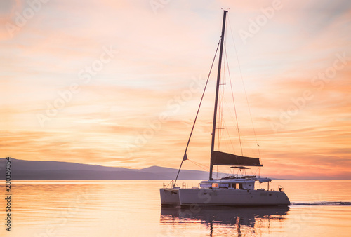 Fototapeta Naklejka Na Ścianę i Meble -  Sailing boat yacht in Mediterranean sea at sunset, travel and active lifestyle concept