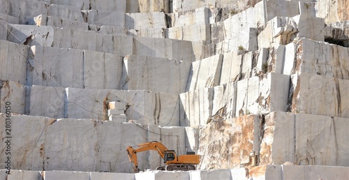 Marble quarry with a Excavator loader, open mining, Italy photo
