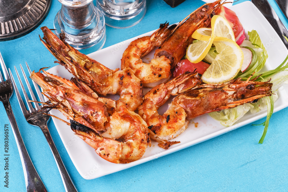 European cuisine, Mediterranean dish. Plate with assorted sea grill for beer. Fried king prawns with lemon, mussels with oyster sauce, Colmar rings, crab meat European cuisine, Mediterranean dish. Plate with assorted sea grill for beer. Fried king prawns with lemon, mussels with oyster sauce, Colmar rings, crab meat