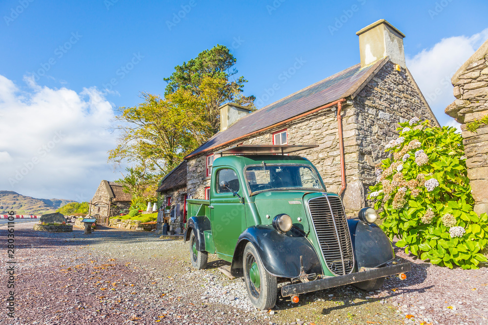 Historic truck in front of an old brick building in Ireland
