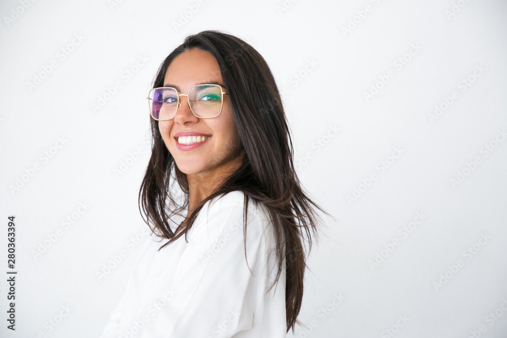 Happy cheerful professional posing in studio. Beautiful young Latin woman in white shirt and stylish eyeglasses smiling at camera. Female portrait concept Happy cheerful professional posing in studio. Beautiful young Latin woman in white shirt and stylish eyeglasses smiling at camera. Female portrait concept