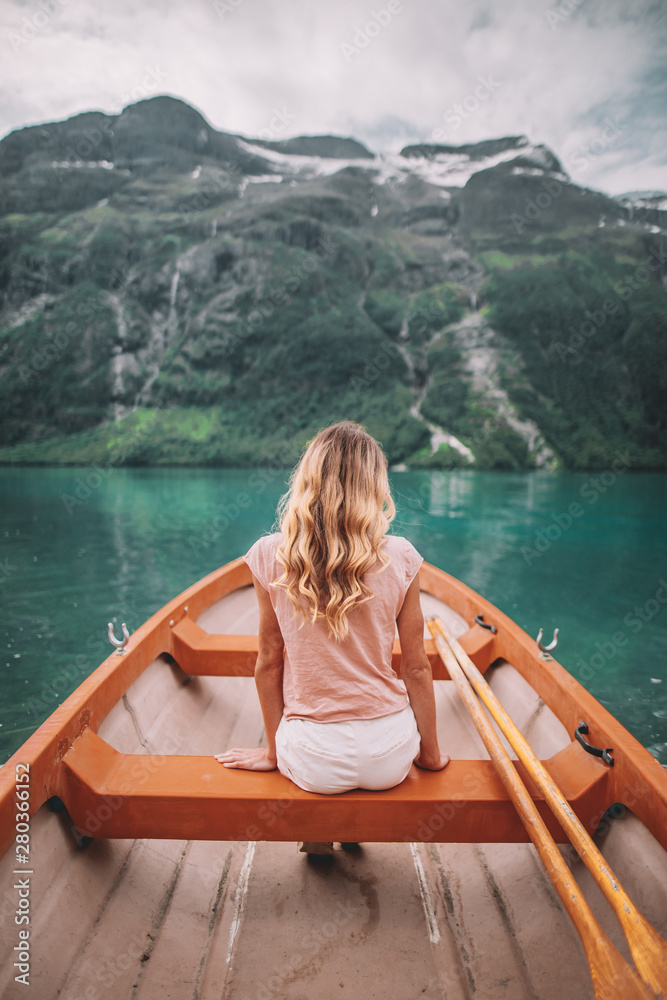 young woman in boat in Lovatnet young woman in boat in Lovatnet