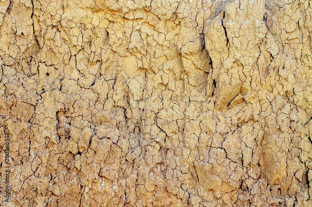 Texture of a steep shore of sandy dry land with cracks. Texture of a steep shore of sandy dry land with cracks.