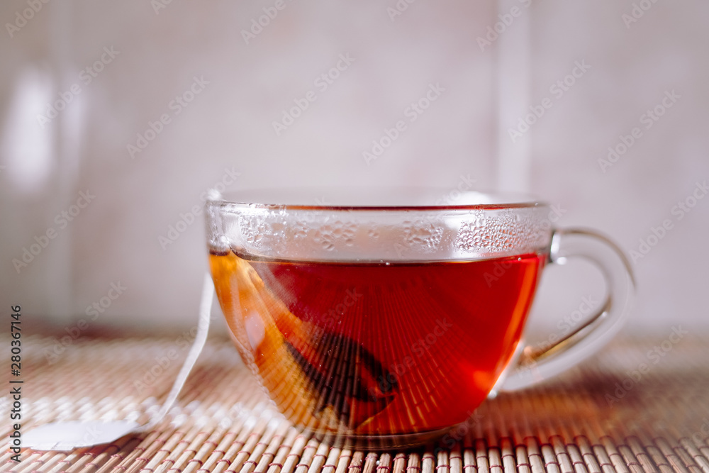 Fototapeta premium tea in a clear glass black