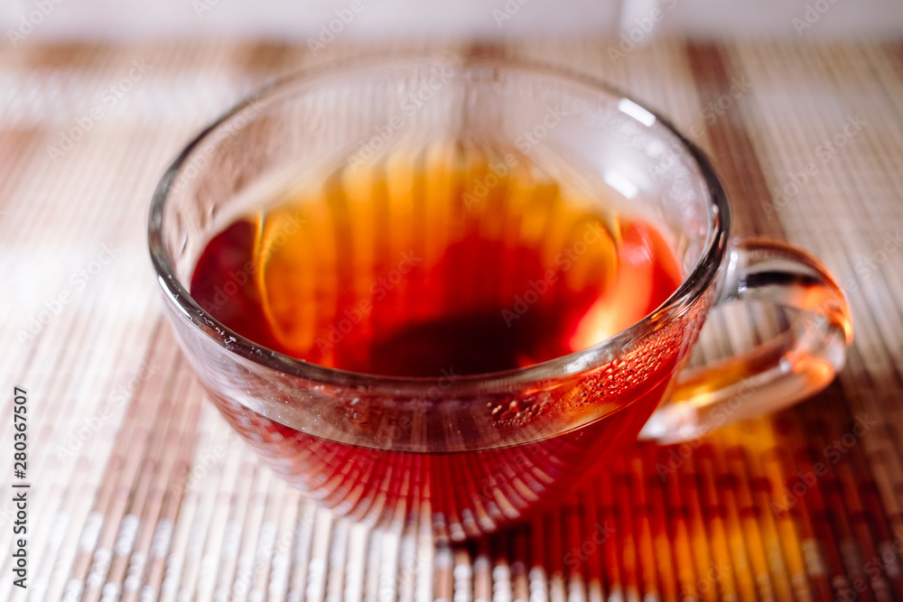 Fototapeta premium tea in a clear glass black