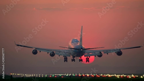 Big airliner landing at sunrise