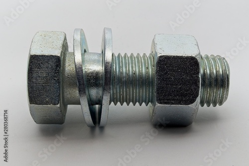 Steel nut, bolt and washers on white background