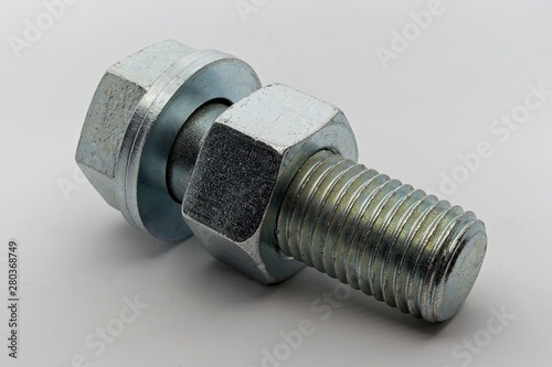 Steel nut, bolt and washers on white background