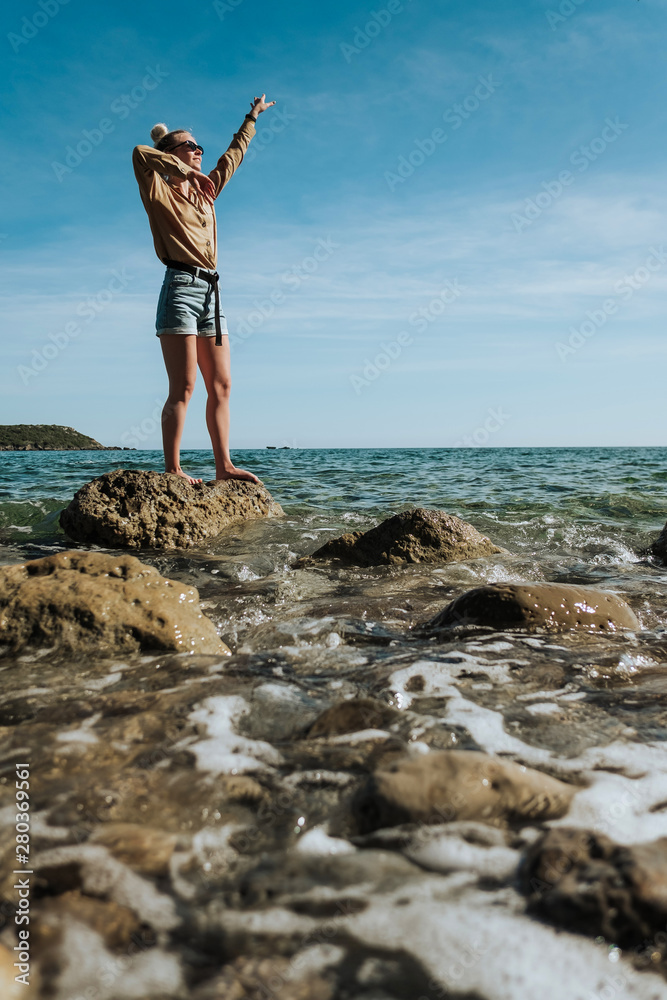 Young happy girl dancing at sea. Young happy girl dancing at sea.