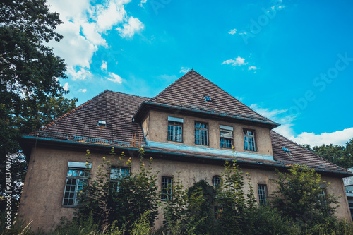 Wallpaper Mural old and rotten house with big bushes in the foreground Torontodigital.ca