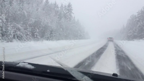 winter roadl in heavy snow with strong blizzard in moving car photo