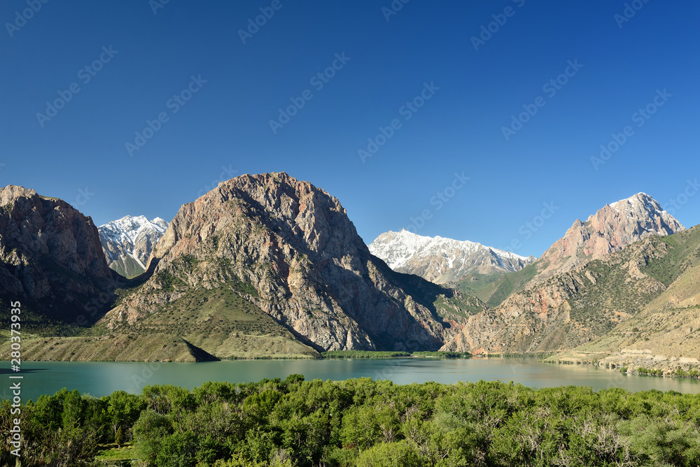 View on Iskander Kul blue mountain lake in the Fan mountains, Tajikistan.