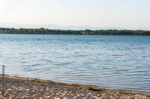 beach on the shore of a mountain lake photo