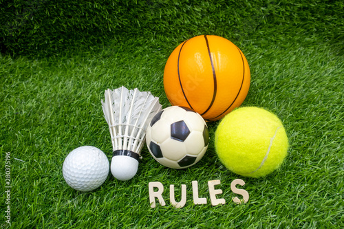 golf ball shuttlecock football basketball and tennis with rules are on green grass