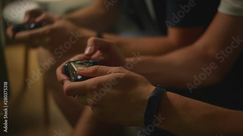 Close up shot of two guys playing video game console