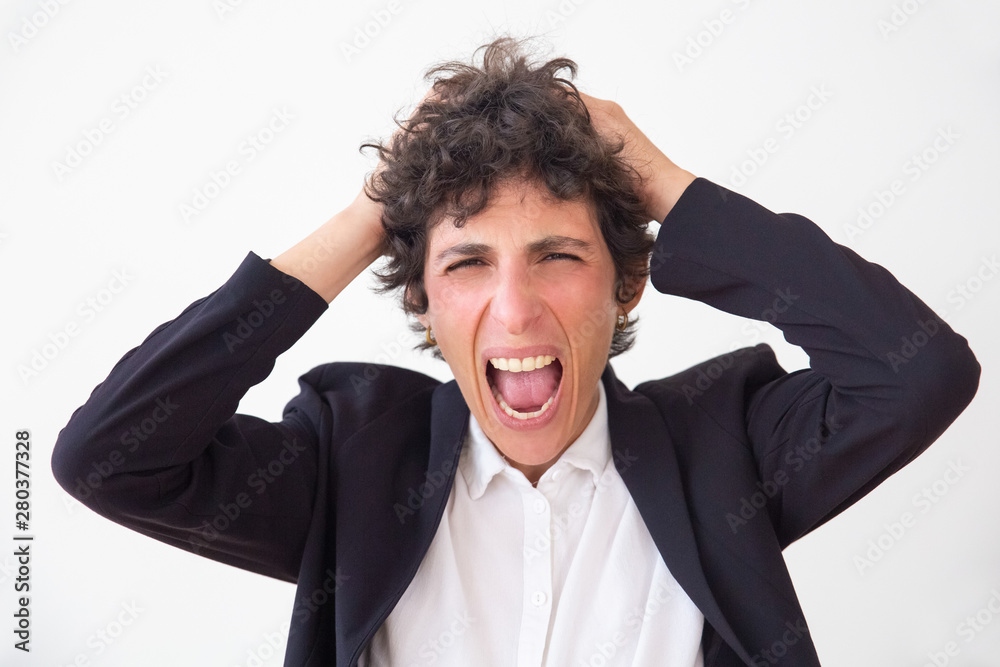 Emotional businesswoman screaming. Portrait of stressed middle aged businesswoman yelling and looking at camera isolated on white background. Emotion concept Emotional businesswoman screaming. Portrait of stressed middle aged businesswoman yelling and looking at camera isolated on white background. Emotion concept