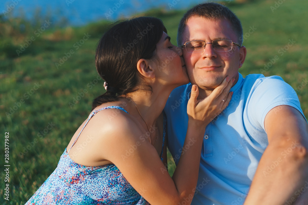 woman kissing man on cheek