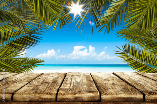 Table background with beautiful blue ocean and sandy beach view. Summer sunny day.