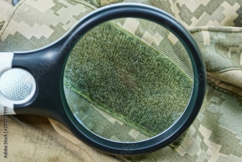 Bild auf Leinwand black magnifier  increases green velcro on spotty clothes