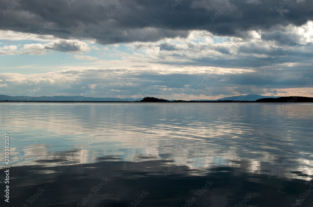 Lake Baikal Russia, reflections of stormy sky in chivyrkuysky bay