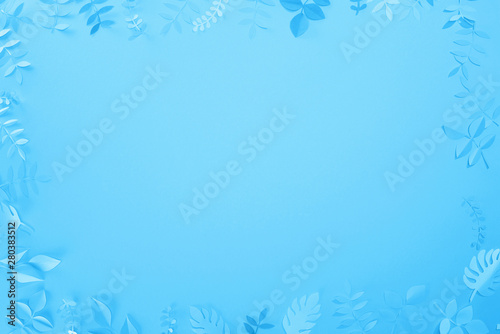 Fototapeta Naklejka Na Ścianę i Meble -  frame of paper cut leaves on blue minimalistic background with copy space