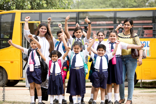 Group of school children with teachers celebrating success