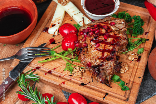 steak of horse meat fried on coals. Grilled meat, with greens, cheese sticks, tomato sauce and nuts with balsamic sauce, Georgian appetizer. National cuisine